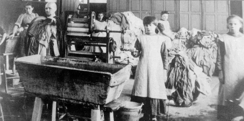 An unidentified Magdalen laundry in Ireland: women and girls at work with primitive washing equipment